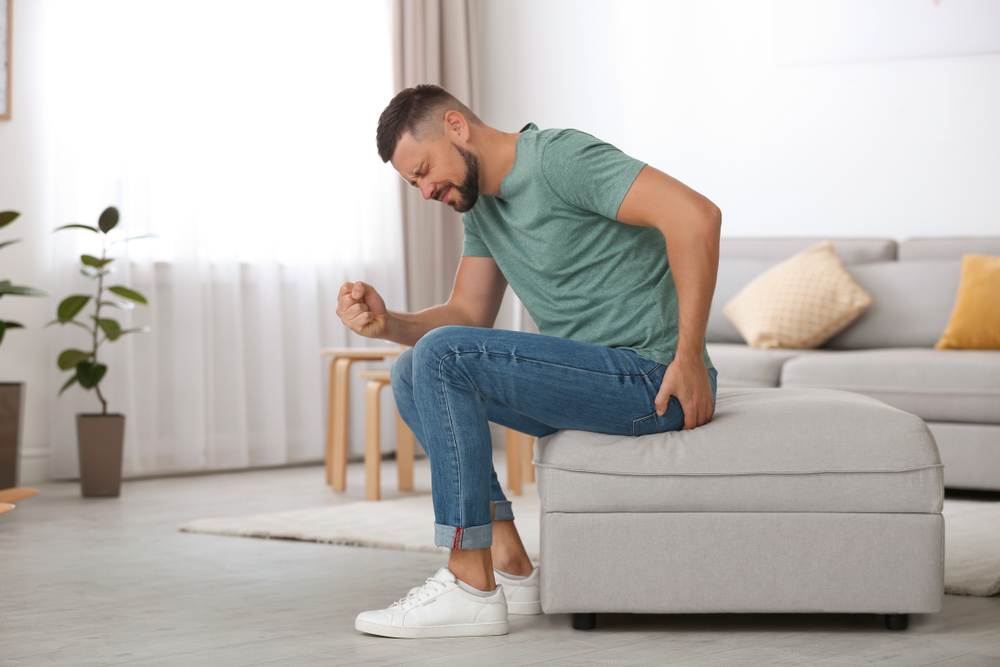 man seated in pain